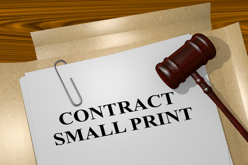 legal papers on a desk with the words contract small print