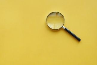 image of a magnifying glass on yellow background