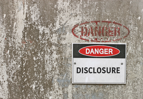 A wall displaying a sign with the words Danger Disclosure
