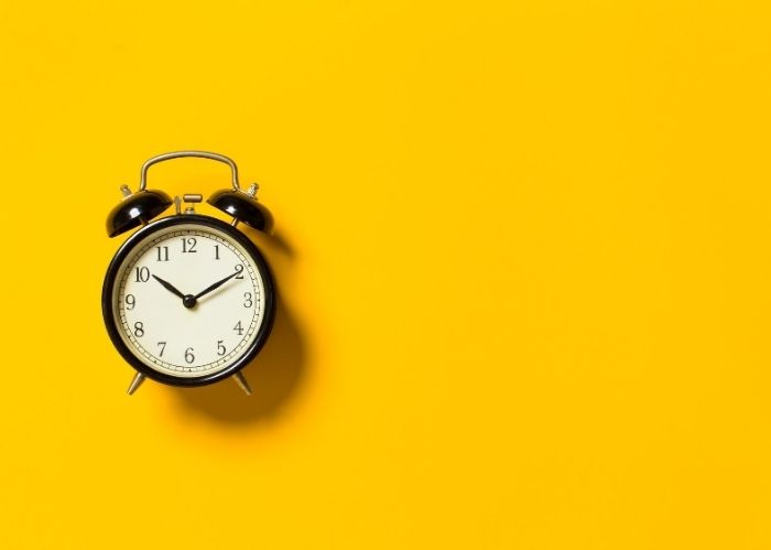 Alarm clock on a yellow background